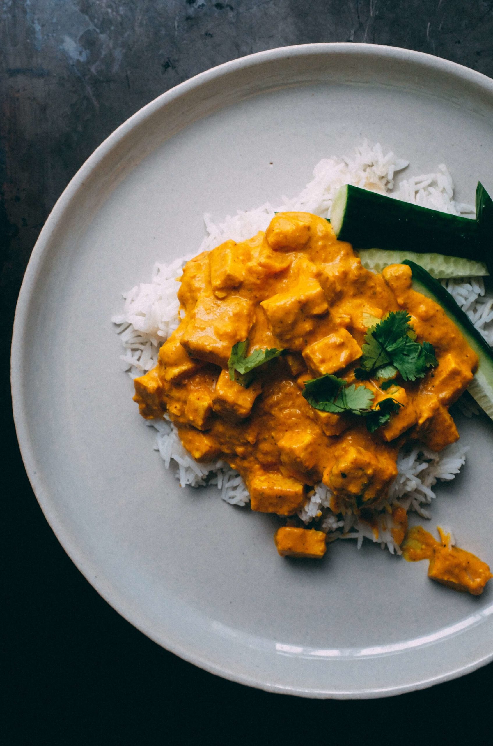 Rice and red curry on a white plate